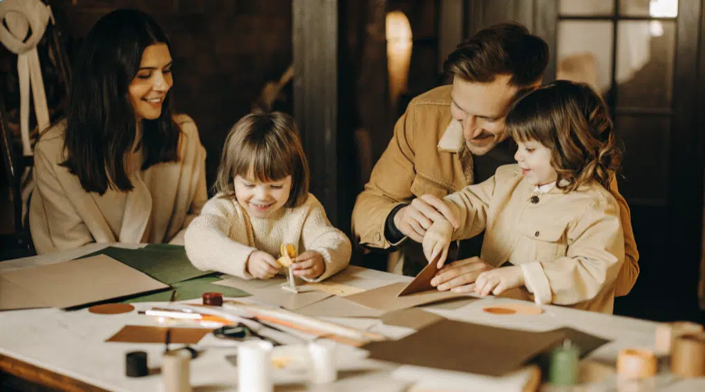 A family engaging in various crafting activities together.