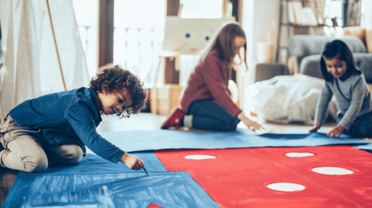 Children painting on the floor.