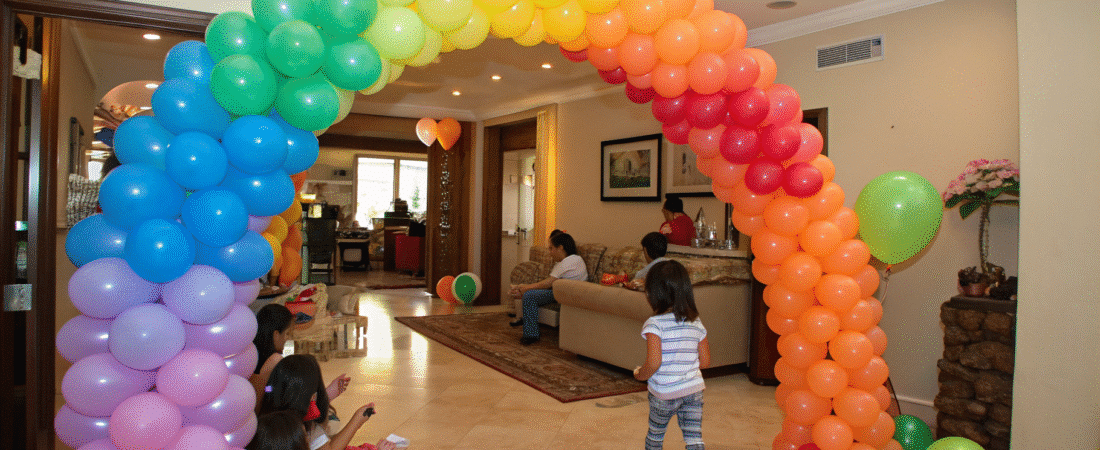 A Balloon Spiral Arch in a lving room.