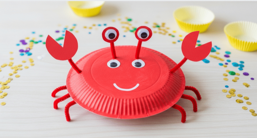 Crafting A Crab Paper Plate A colorful crab paper plate craft displayed on a table.