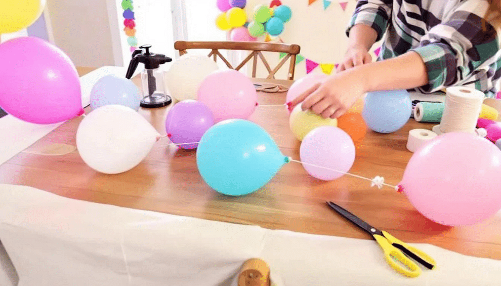 DIY Balloon Garland The image shows a vibrant DIY balloon garland made from a variety of balloons in different sizes and colors, perfect for a birthday party. The garland is elegantly draped across a wall, showcasing creative balloon decoration ideas that add a festive touch to any celebration.