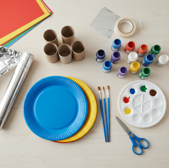 Materials needed for making rocket ship crafts, including paper plates and paint.
