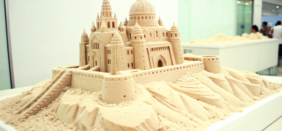 A Sand building on a table.