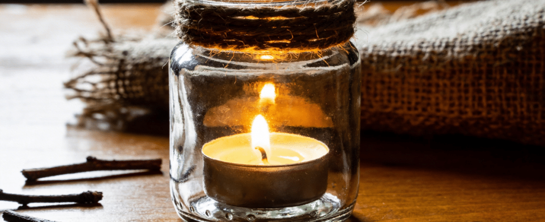 Candle jar on table.