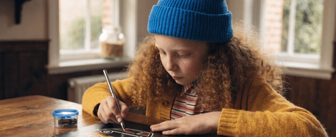 A child using scratch card for art.