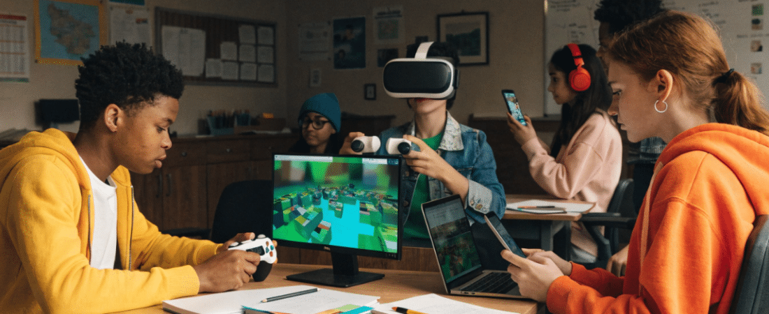 Children on VR and laptops playing games.