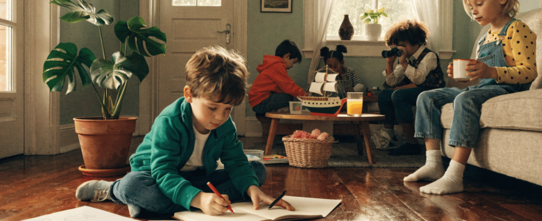 Things to Do with Preschoolers at Home Five children enjoy things to do with preschoolers at home: one draws on the floor with crayons, three play at a coffee table with a toy ship and binoculars, while another sits on a couch with a cup. The room feels cozy with plants and framed art.