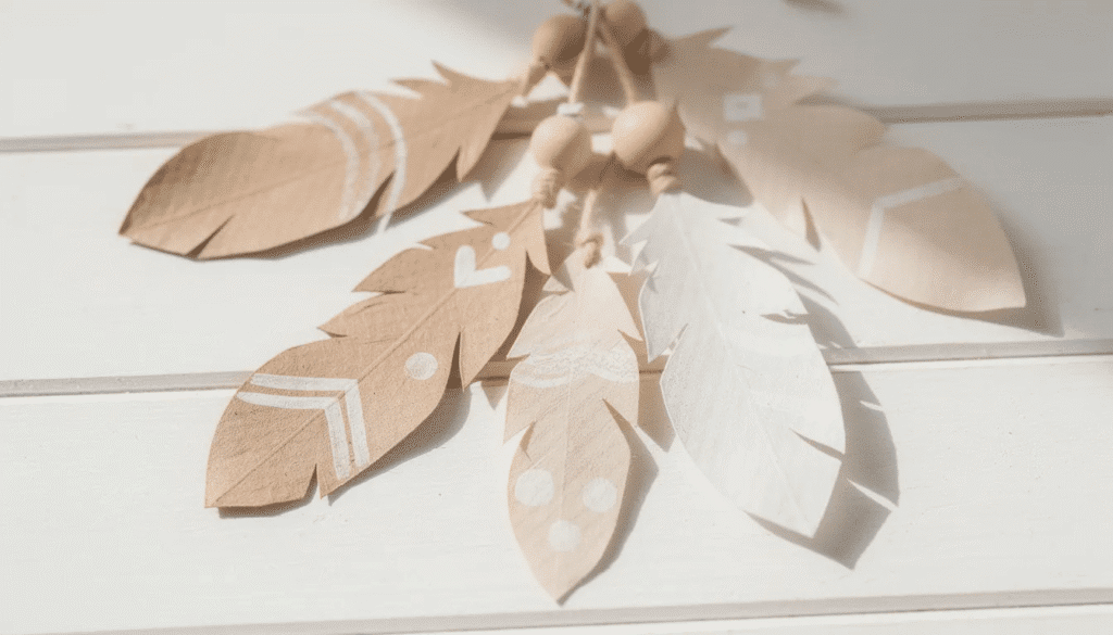 The image features simple paper feathers crafted for boho decorations, showcasing a variety of colors and patterns. These lightweight embellishments highlight the creativity of paper craft, perfect for adding a unique touch to party decor or handmade cards.